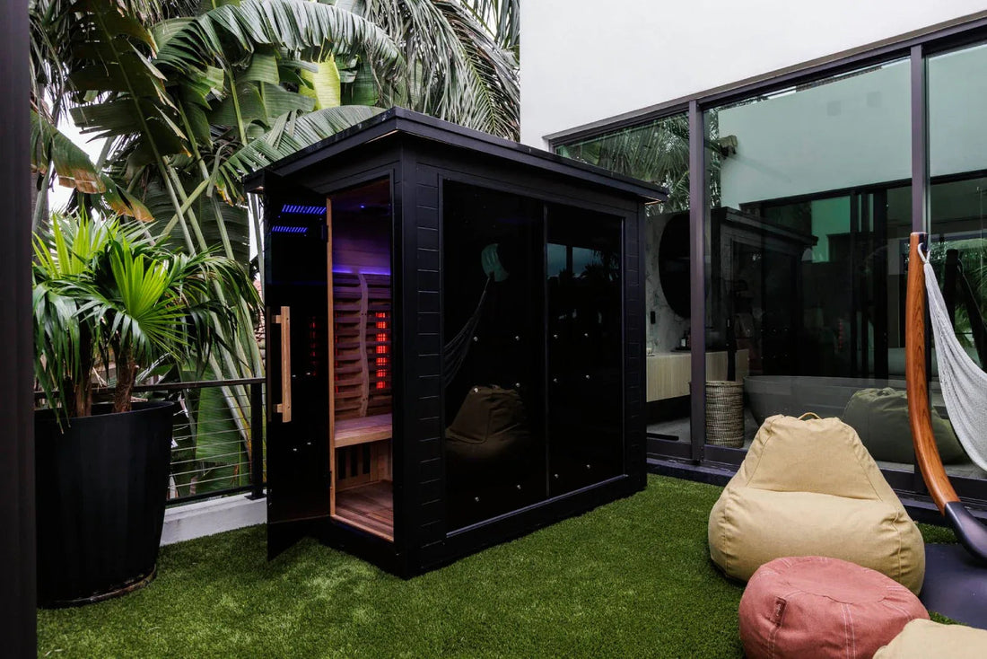 Modern black sauna cabin with glowing interior.