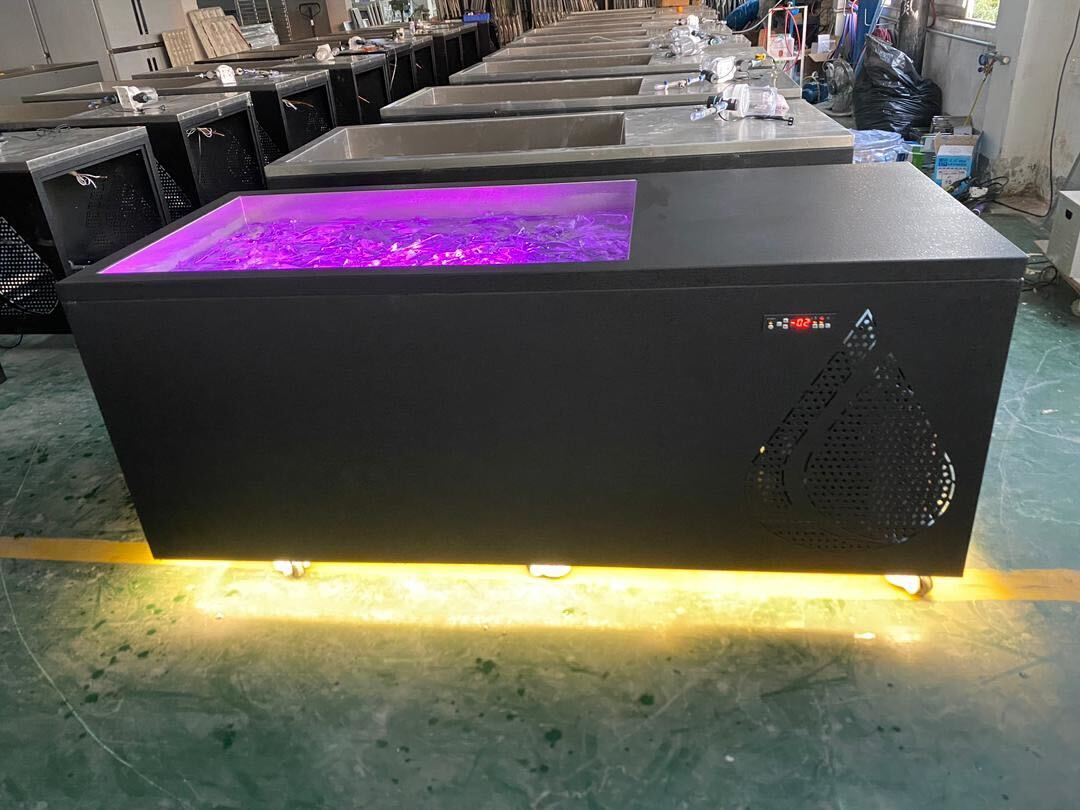 Black cold plunge tub with purple LED lighting.