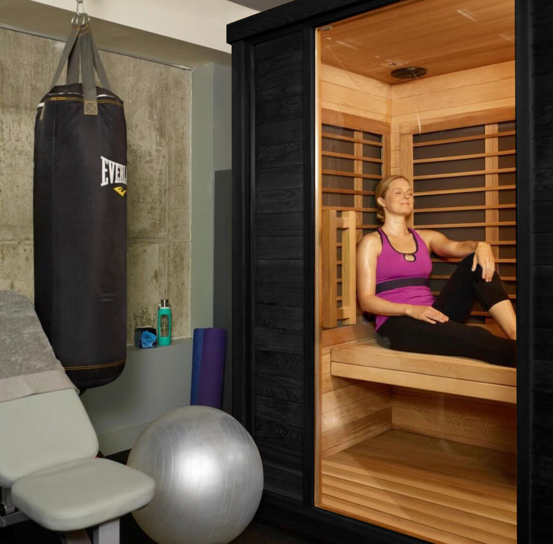 Gym with sauna, punching bag, and exercise ball.