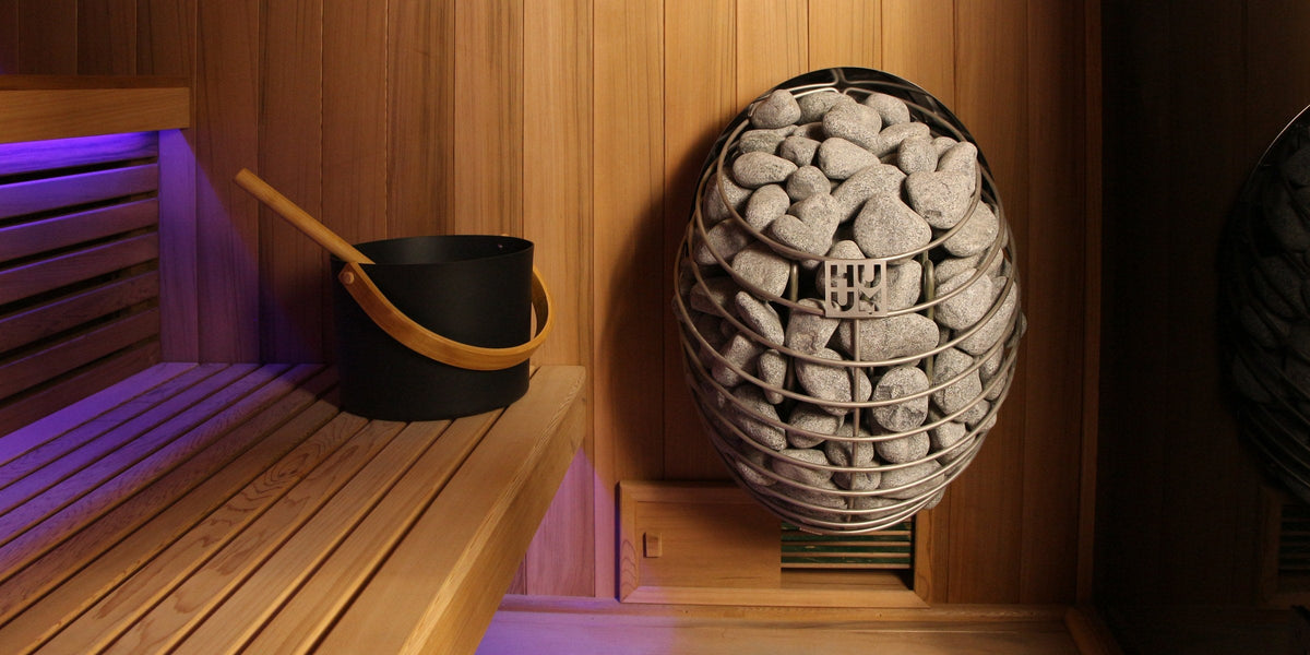 Interior of a Sun Home traditional sauna with cedar walls and a HUUM heater
