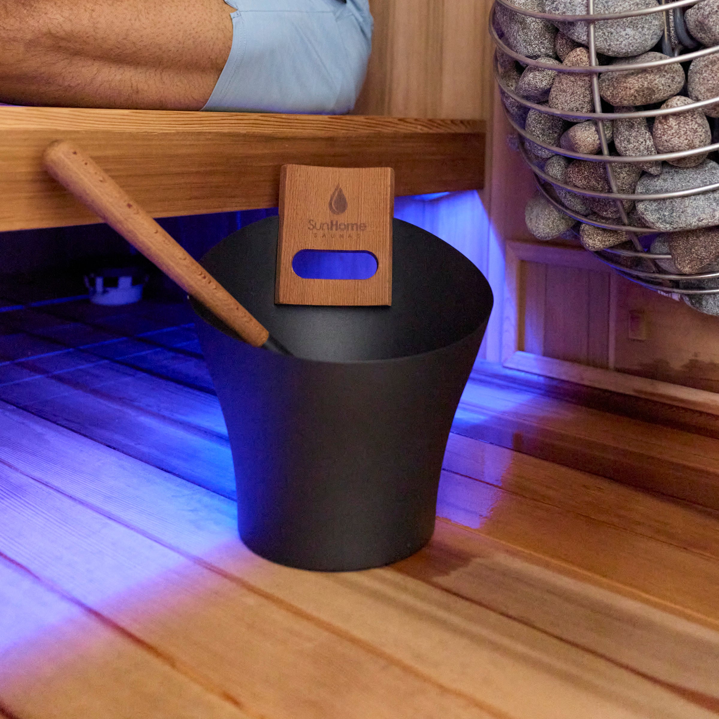 Sun Home sauna bucket and ladle beside a traditional sauna heater