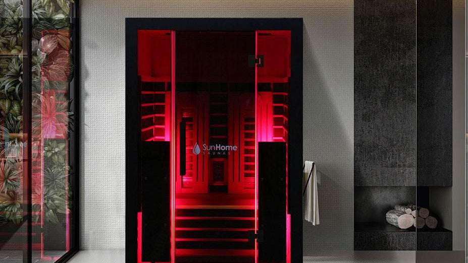 Sun Home infrared sauna with a glass front and warm-lit wood interior