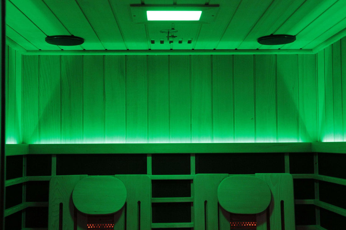 Sun Home Eclipse 2-person red light infrared sauna interior lit in green chromotherapy with red-glowing heaters