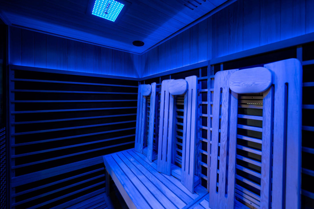 Interior of the Sun Home Eclipse 4-person infrared sauna lit with blue chromotherapy lighting