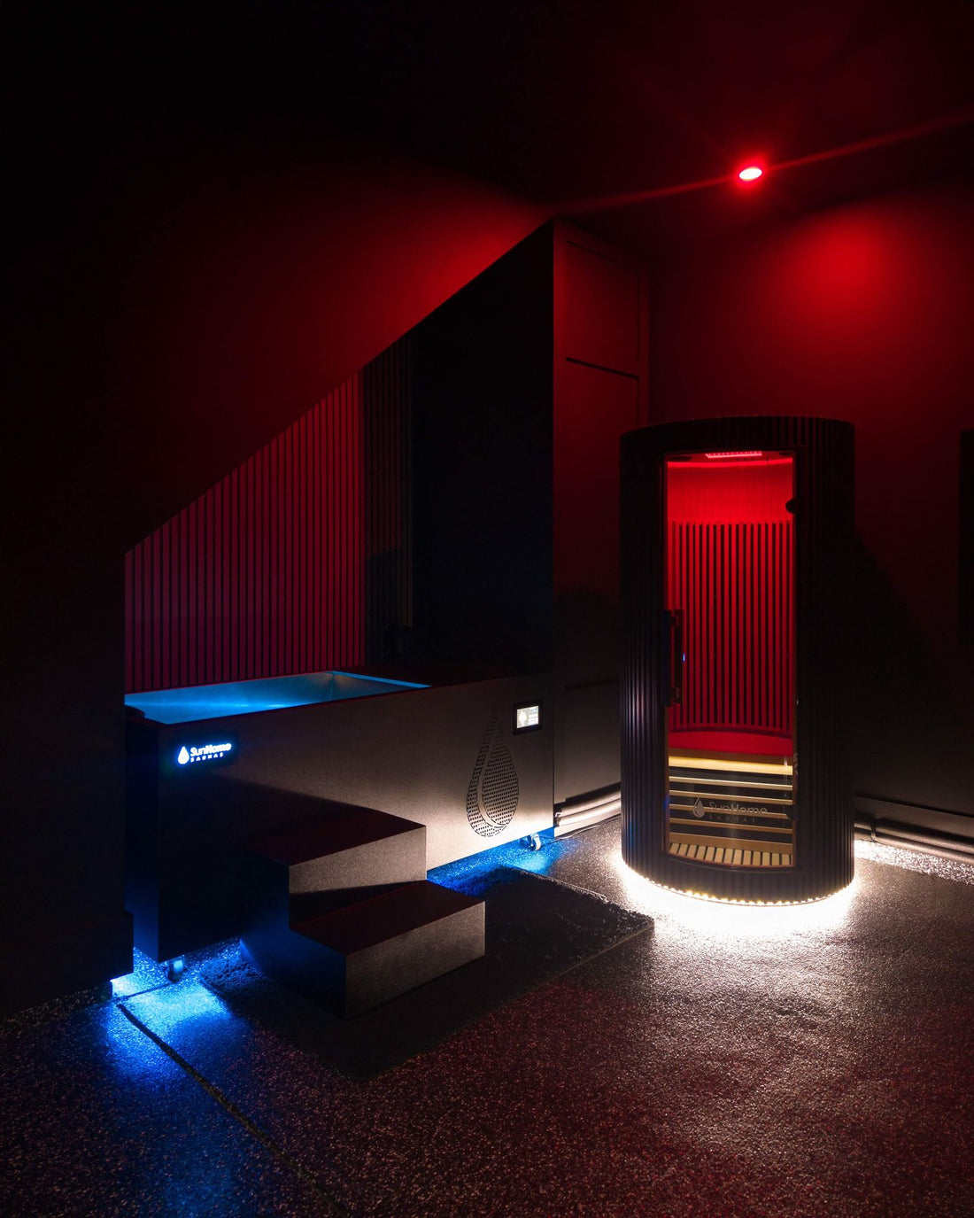 Sun Home Pod 1-person red light infrared sauna beside a cold plunge in a dark spa room